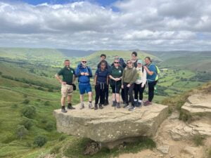 A group from Walking 4 Hope - a mental Health Charity in Nottinghamshire - pose on top of Lose Hill in the Peak District in their walking gear