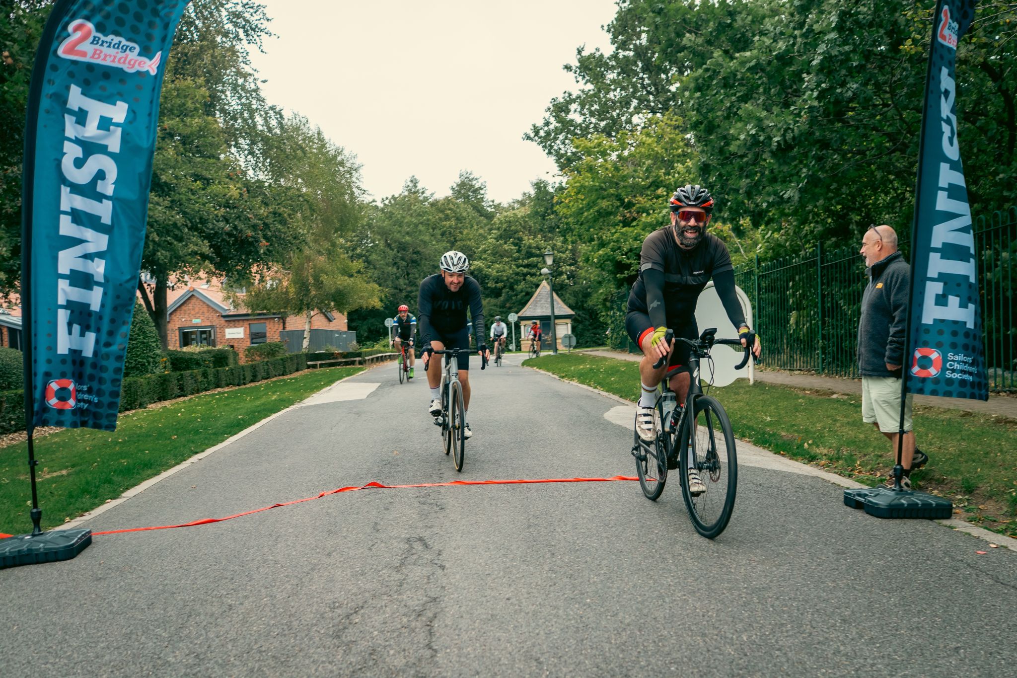 Adam Walsh crosses the Bridge2Bridge finish line on his cycle