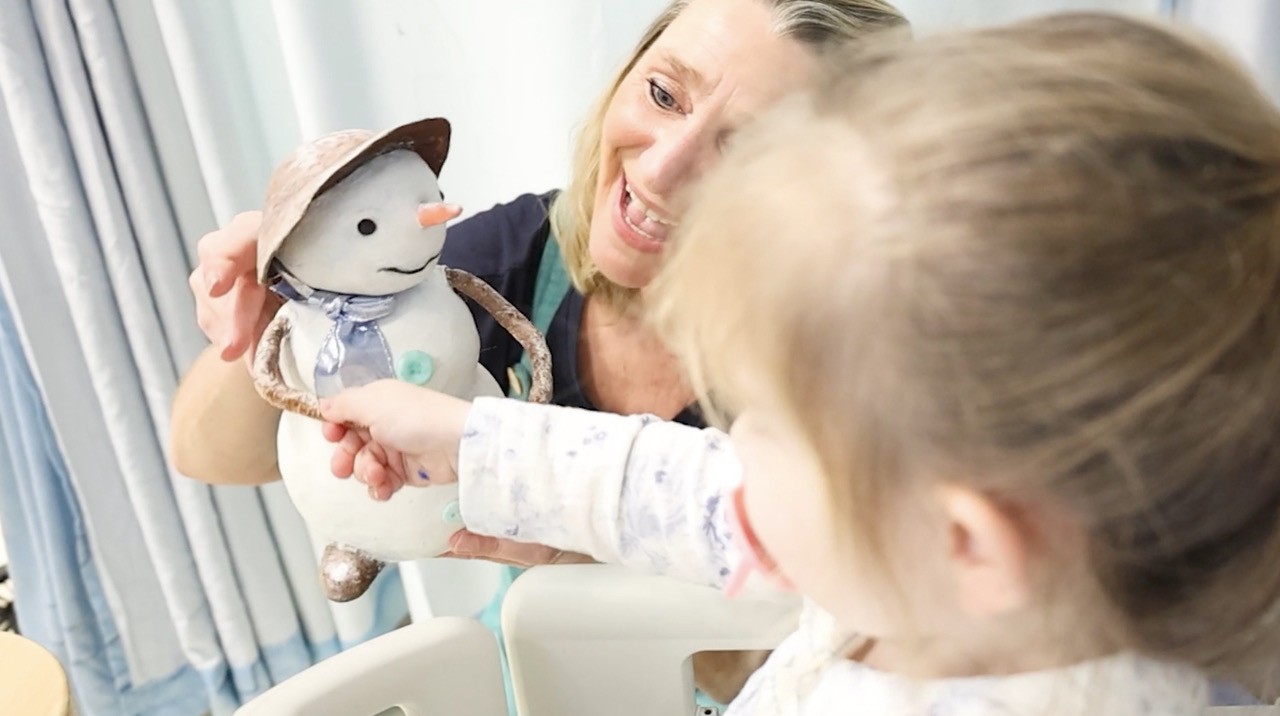 Performance artists entertain young oncology patients as part of a hospital arts programme